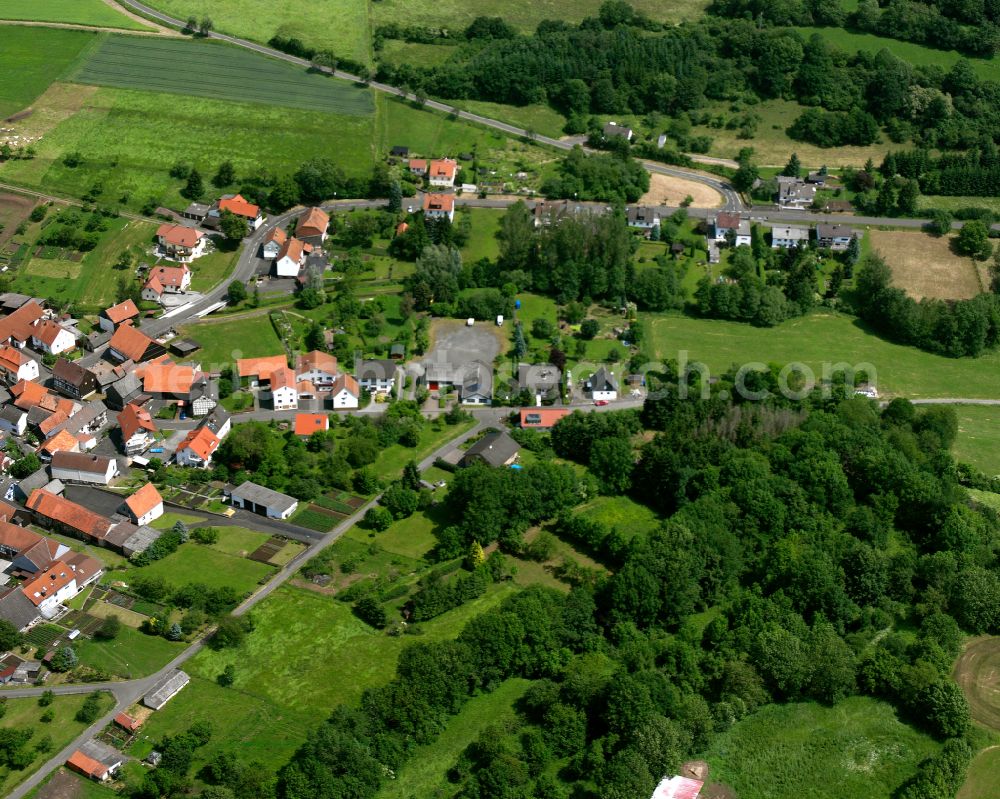 Elpenrod from above - Agricultural land and field boundaries surround the settlement area of the village in Elpenrod in the state Hesse, Germany