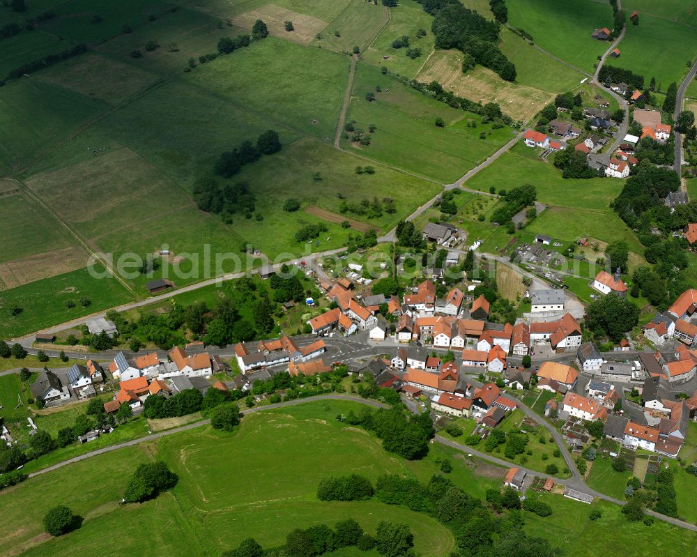 Elpenrod from above - Agricultural land and field boundaries surround the settlement area of the village in Elpenrod in the state Hesse, Germany