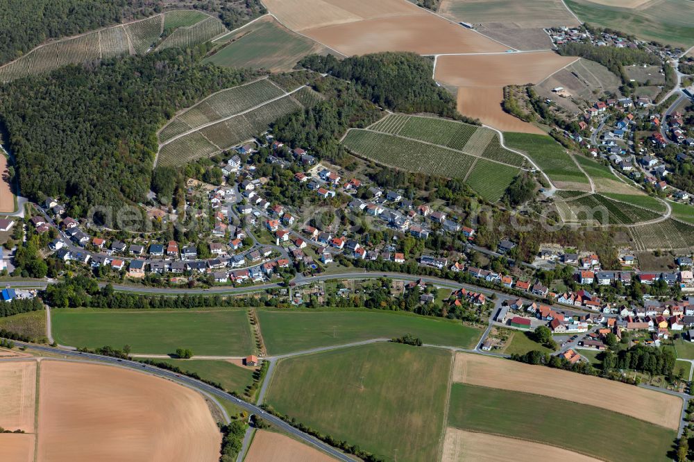 Erlenbach bei Marktheidenfeld from above - Agricultural land and field boundaries surround the settlement area of the village in Erlenbach bei Marktheidenfeld in the state Bavaria, Germany