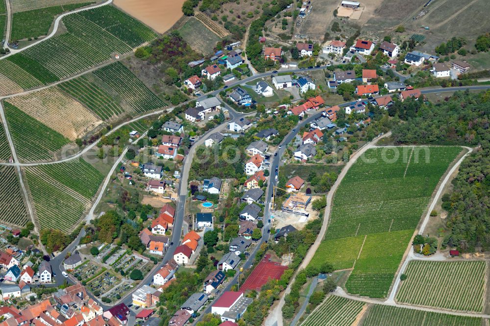 Erlenbach bei Marktheidenfeld from the bird's eye view: Agricultural land and field boundaries surround the settlement area of the village in Erlenbach bei Marktheidenfeld in the state Bavaria, Germany