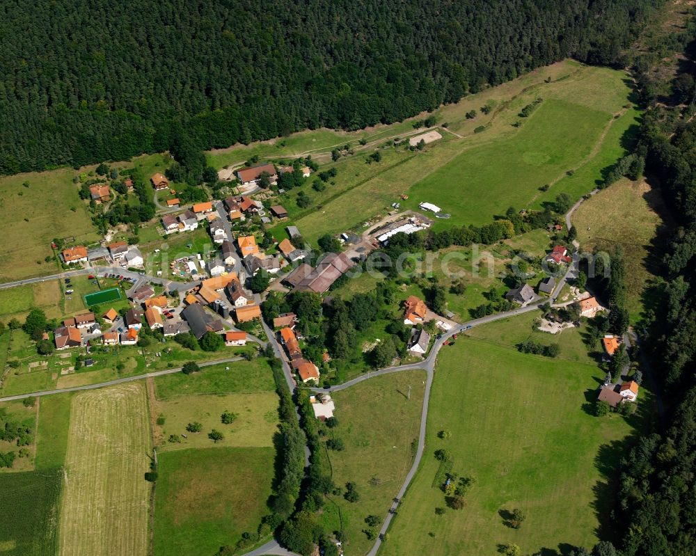 Aerial photograph Ernsbach - Agricultural land and field boundaries surround the settlement area of the village in Ernsbach in the state Hesse, Germany