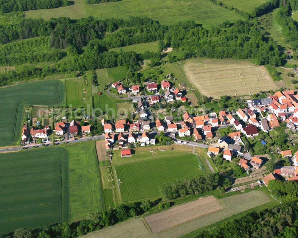 Ershausen from the bird's eye view: Agricultural land and field boundaries surround the settlement area of the village in Ershausen in the state Thuringia, Germany