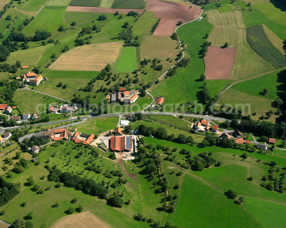 Aerial image Erzbach - Agricultural land and field boundaries surround the settlement area of the village in Erzbach in the state Hesse, Germany