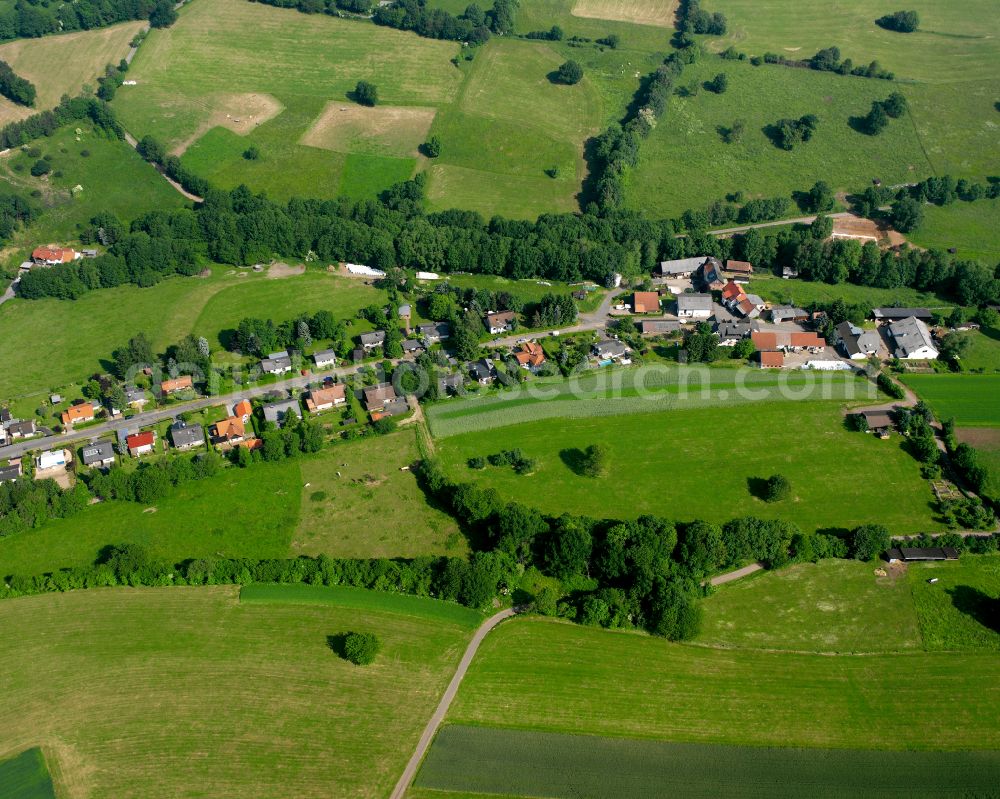 Aerial photograph Eschenrod - Agricultural land and field boundaries surround the settlement area of the village in Eschenrod in the state Hesse, Germany