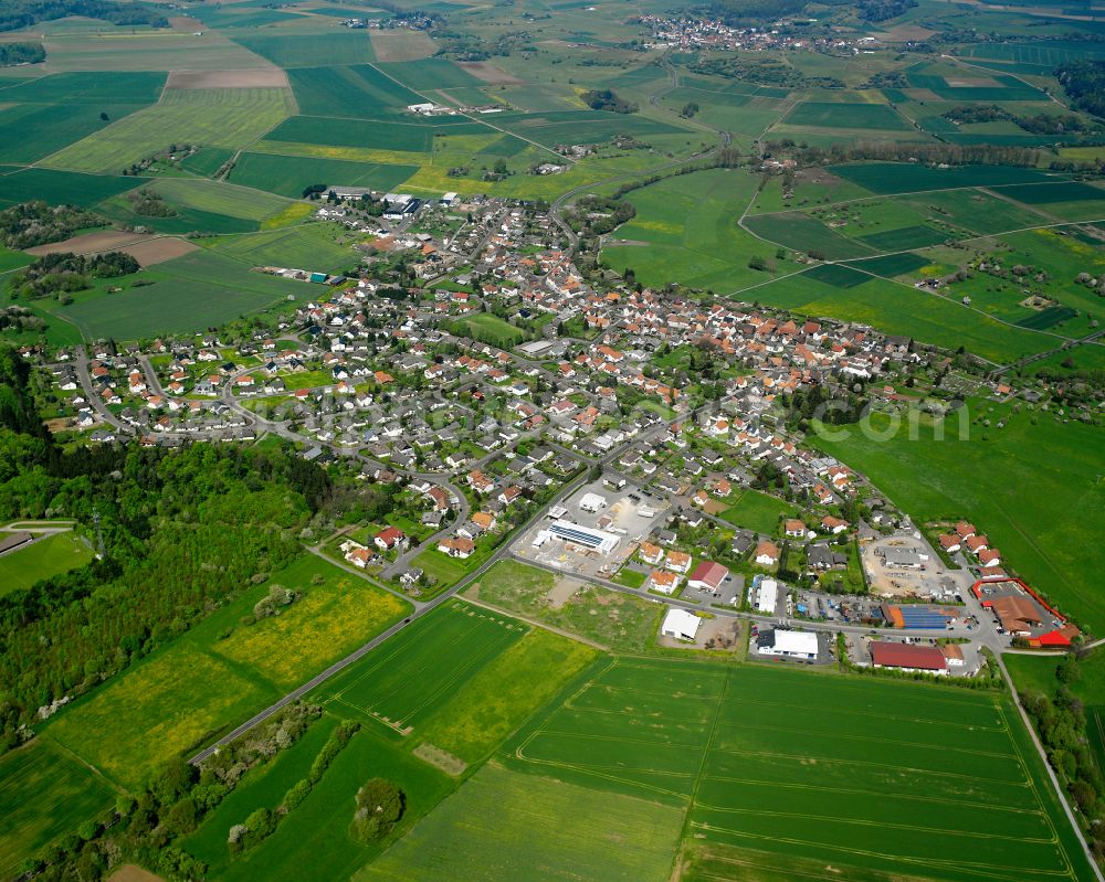 Ettingshausen from above - Agricultural land and field boundaries surround the settlement area of the village in Ettingshausen in the state Hesse, Germany