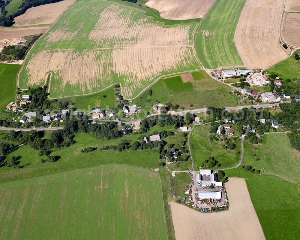 Etzdorf from above - Agricultural land and field boundaries surround the settlement area of the village in Etzdorf in the state Saxony, Germany