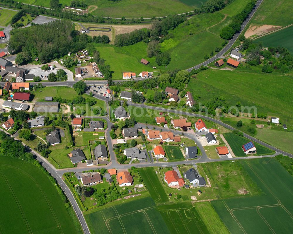 Eudorf from the bird's eye view: Agricultural land and field boundaries surround the settlement area of the village in Eudorf in the state Hesse, Germany