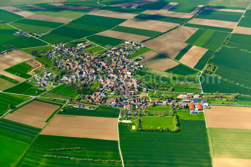 Euerfeld from the bird's eye view: Agricultural land and field boundaries surround the settlement area of the village in Euerfeld in the state Bavaria, Germany