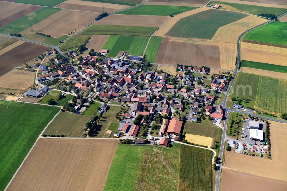 Euerhausen from the bird's eye view: Agricultural land and field boundaries surround the settlement area of the village in Euerhausen in the state Bavaria, Germany