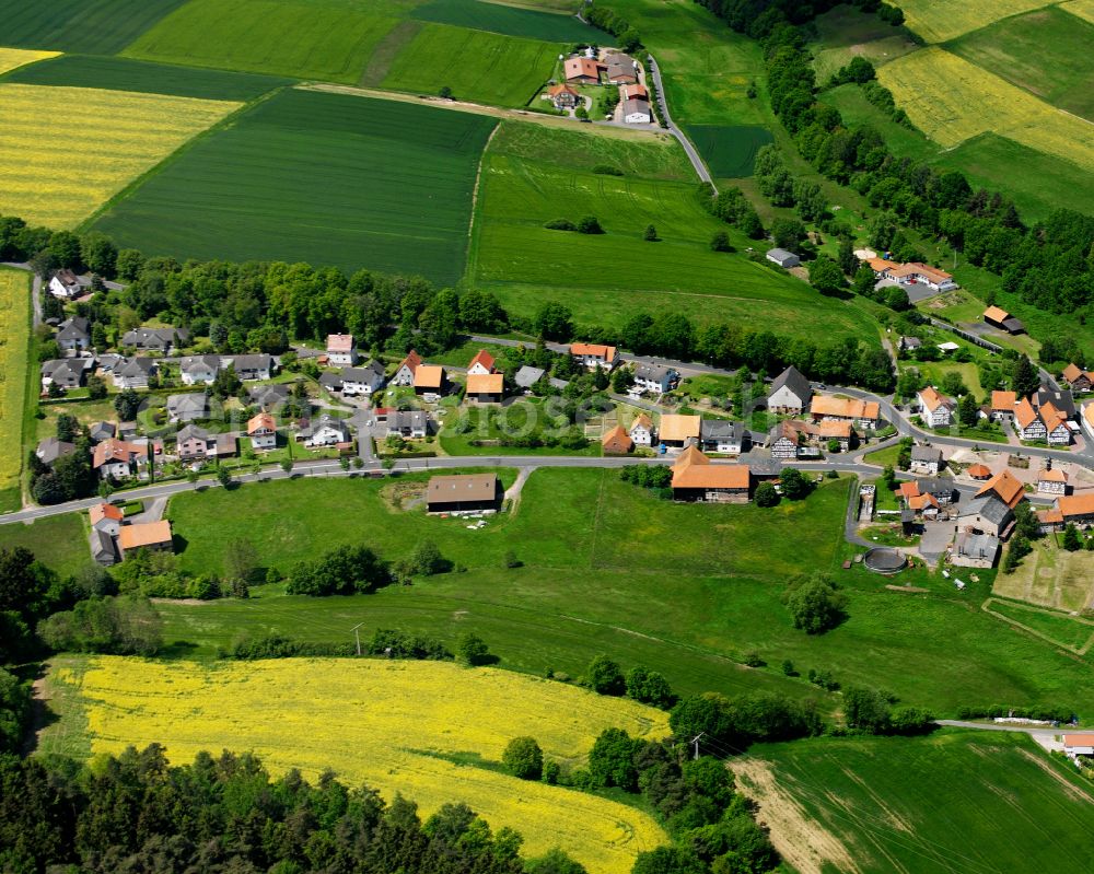 Eulersdorf from the bird's eye view: Agricultural land and field boundaries surround the settlement area of the village in Eulersdorf in the state Hesse, Germany