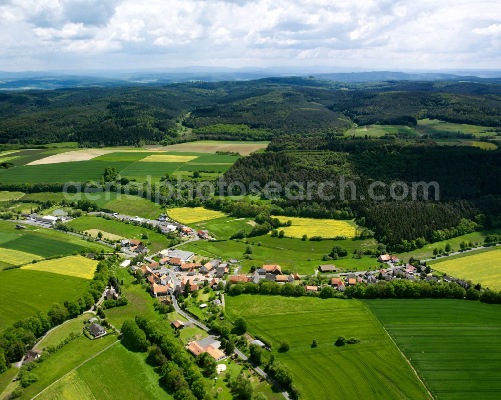 Eulersdorf from above - Agricultural land and field boundaries surround the settlement area of the village in Eulersdorf in the state Hesse, Germany