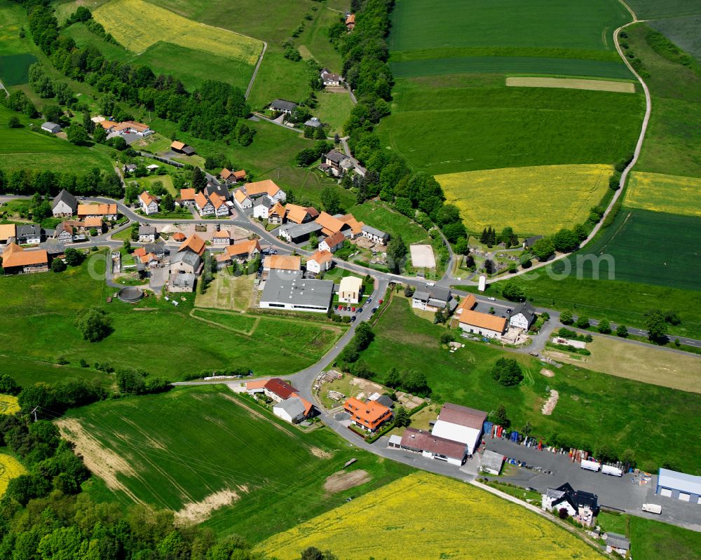 Eulersdorf from the bird's eye view: Agricultural land and field boundaries surround the settlement area of the village in Eulersdorf in the state Hesse, Germany