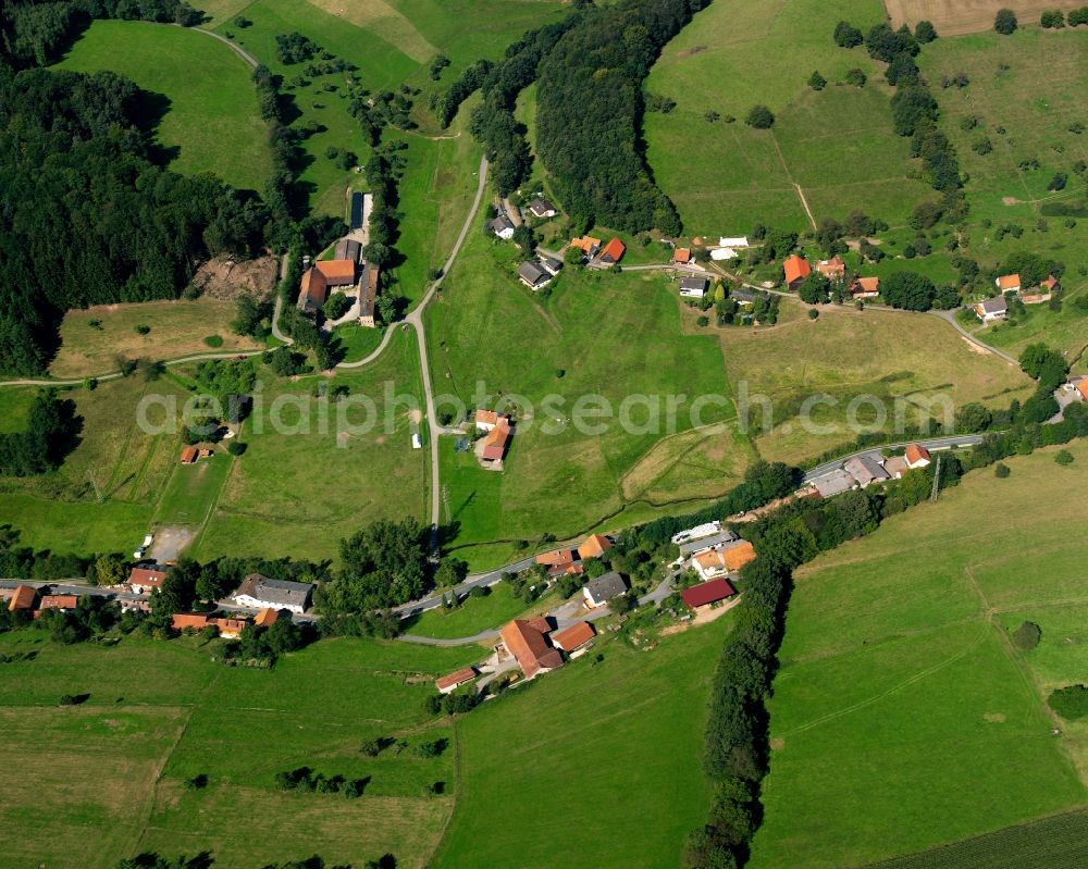 Falken-Gesäß from above - Agricultural land and field boundaries surround the settlement area of the village in Falken-Gesäß in the state Hesse, Germany