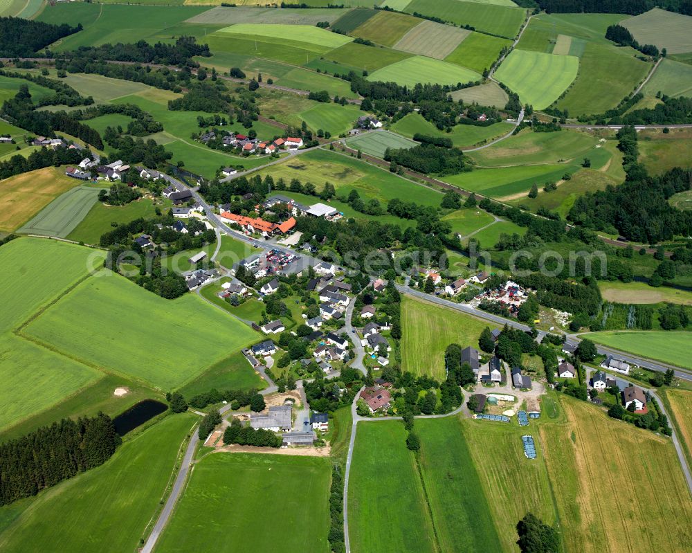 Fattigau from above - Agricultural land and field boundaries surround the settlement area of the village in Fattigau in the state Bavaria, Germany