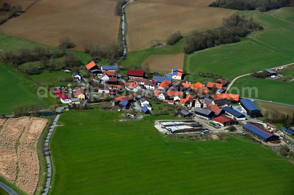 Feldbuch from above - Agricultural land and field boundaries surround the settlement area of the village in Feldbuch in the state Bavaria, Germany