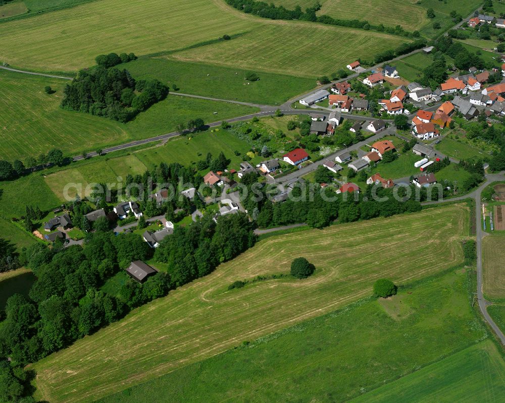 Aerial image Feldkrücken - Agricultural land and field boundaries surround the settlement area of the village in Feldkrücken in the state Hesse, Germany