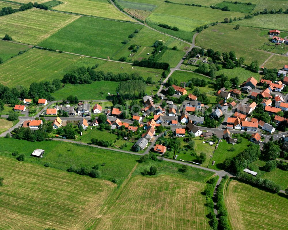 Feldkrücken from above - Agricultural land and field boundaries surround the settlement area of the village in Feldkrücken in the state Hesse, Germany