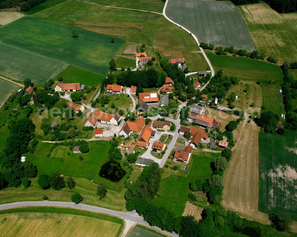 Fetschendorf from above - Agricultural land and field boundaries surround the settlement area of the village in Fetschendorf in the state Bavaria, Germany