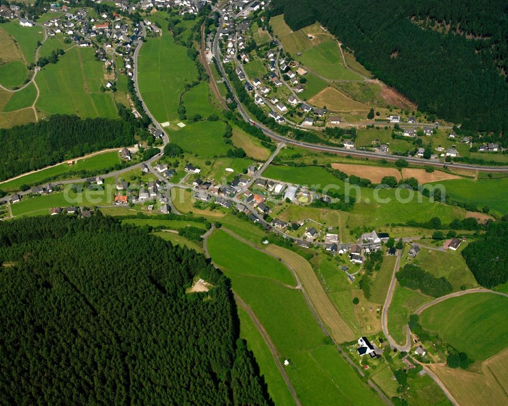 Aerial image Feudingen - Agricultural land and field boundaries surround the settlement area of the village in Feudingen in the state North Rhine-Westphalia, Germany