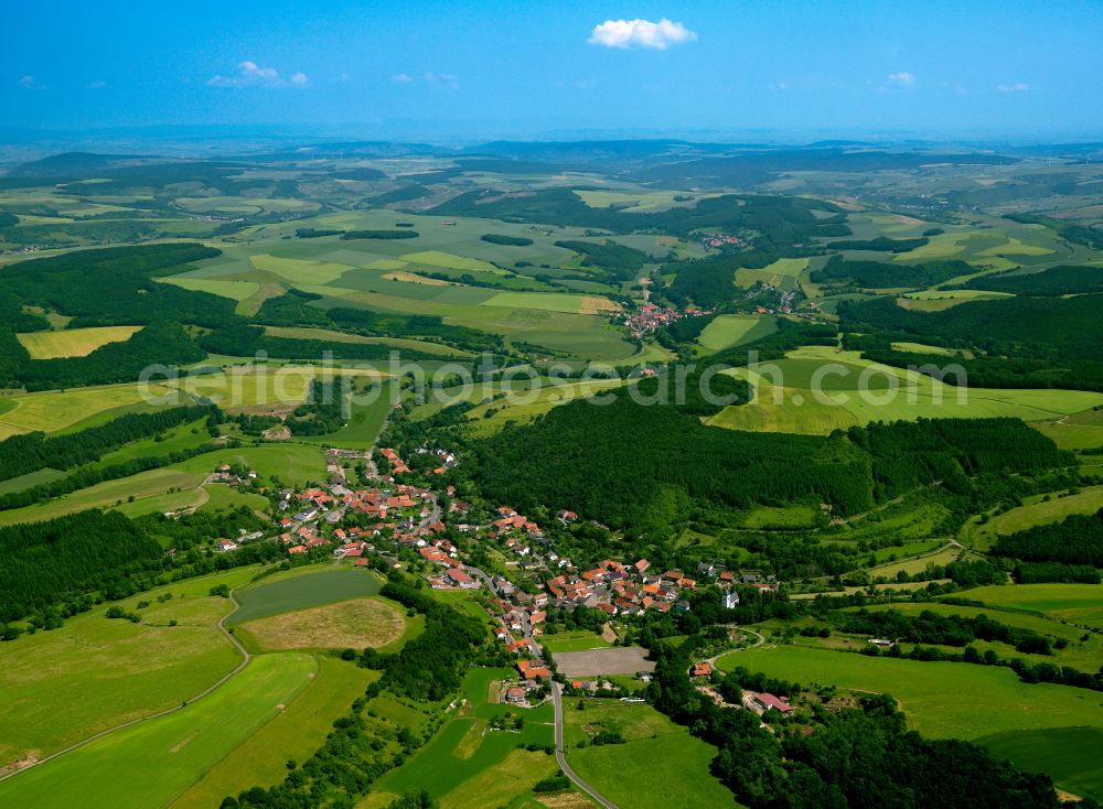 Finkenbach-Gersweiler from the bird's eye view: Agricultural land and field boundaries surround the settlement area of the village in Finkenbach-Gersweiler in the state Rhineland-Palatinate, Germany