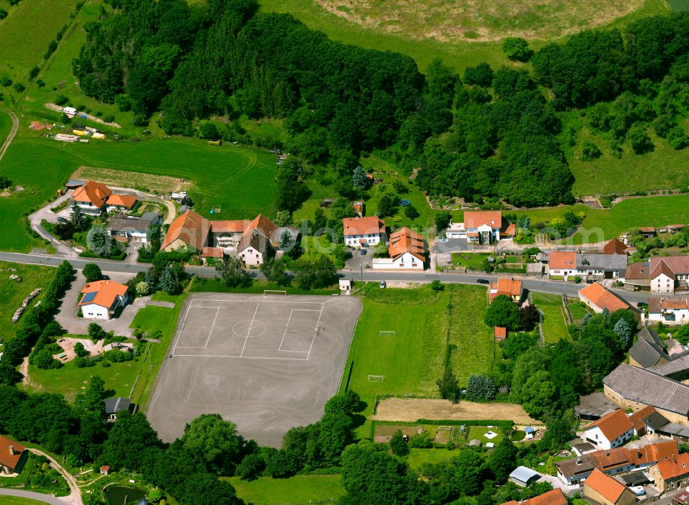 Finkenbach-Gersweiler from the bird's eye view: Agricultural land and field boundaries surround the settlement area of the village in Finkenbach-Gersweiler in the state Rhineland-Palatinate, Germany