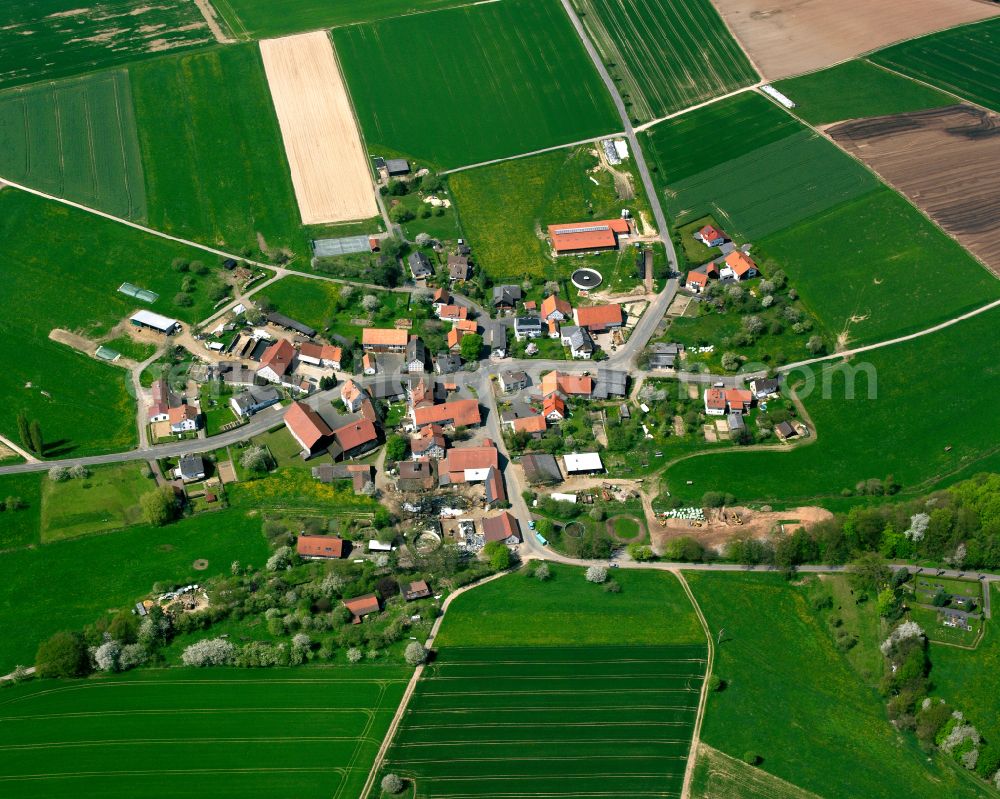 Aerial image Fischbach - Agricultural land and field boundaries surround the settlement area of the village in Fischbach in the state Hesse, Germany