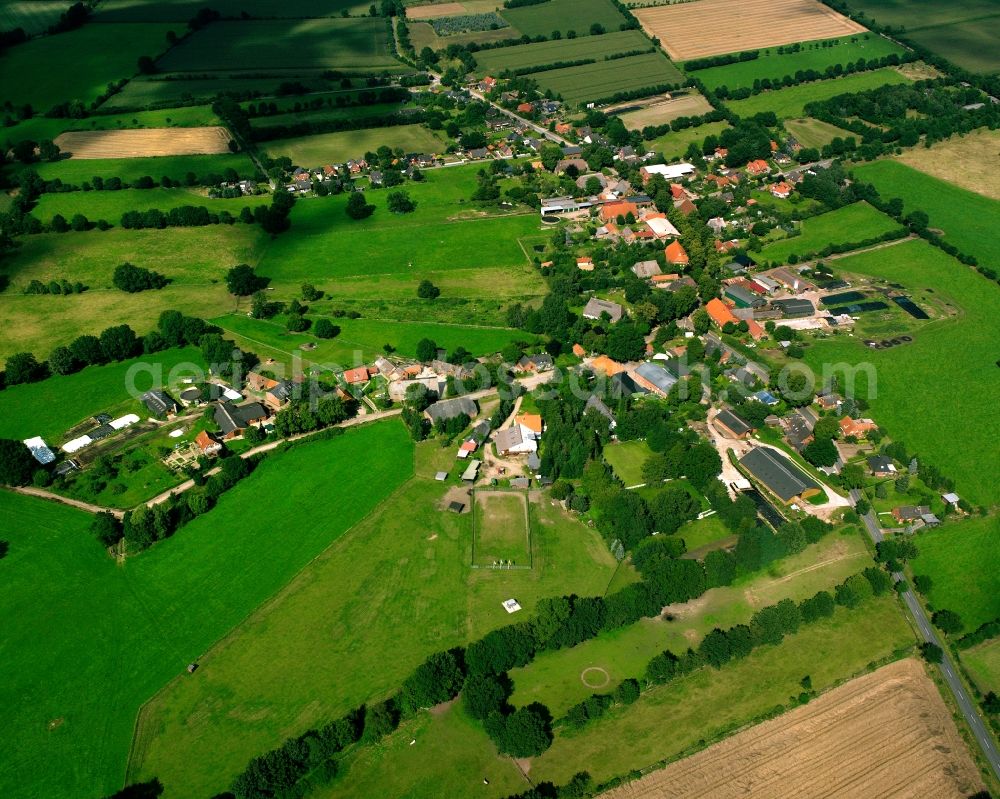 Fitzen from above - Agricultural land and field boundaries surround the settlement area of the village in Fitzen in the state Schleswig-Holstein, Germany