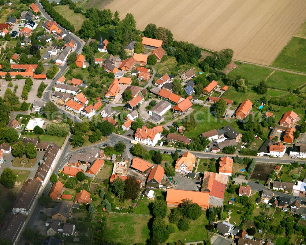 Flachstöckheim from above - Agricultural land and field boundaries surround the settlement area of the village in Flachstöckheim in the state Lower Saxony, Germany