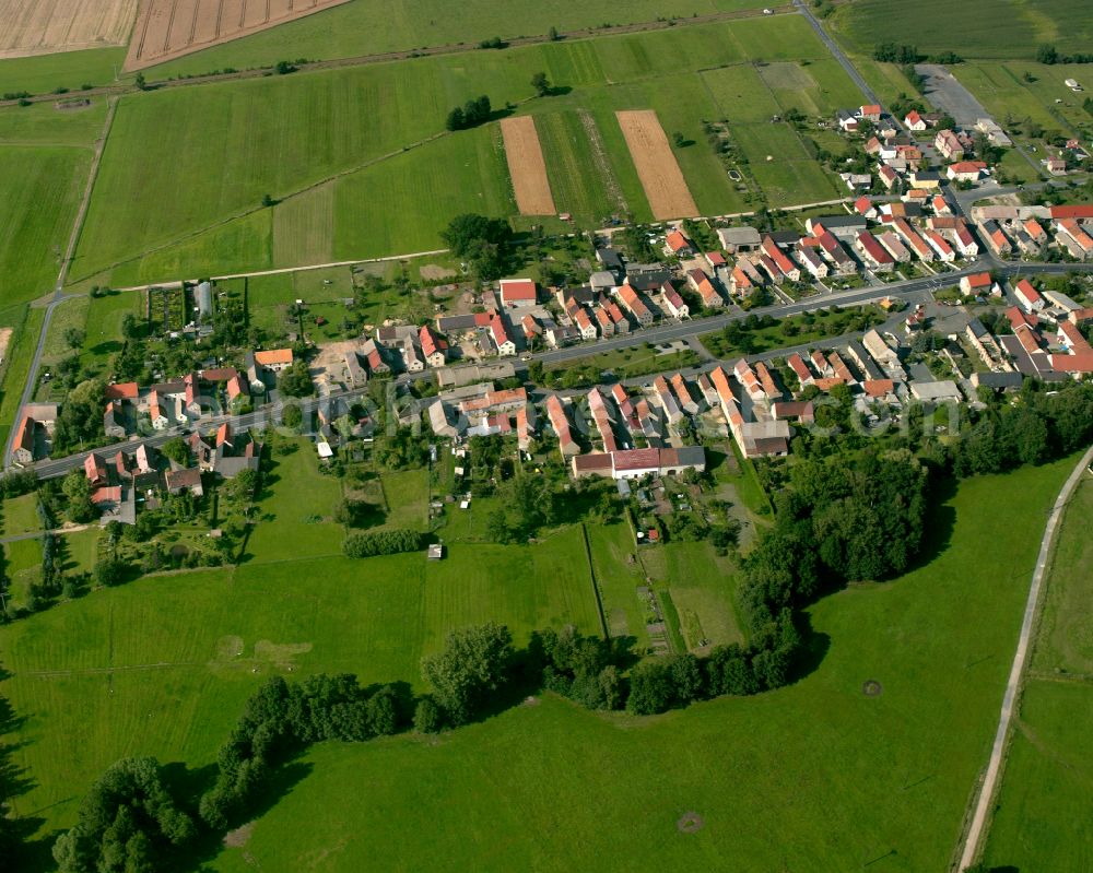 Folbern from the bird's eye view: Agricultural land and field boundaries surround the settlement area of the village in Folbern in the state Saxony, Germany