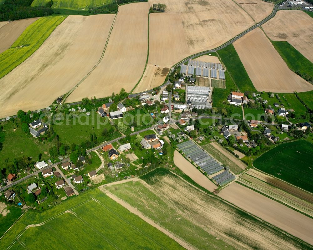 Frankenau from above - Agricultural land and field boundaries surround the settlement area of the village in Frankenau in the state Saxony, Germany