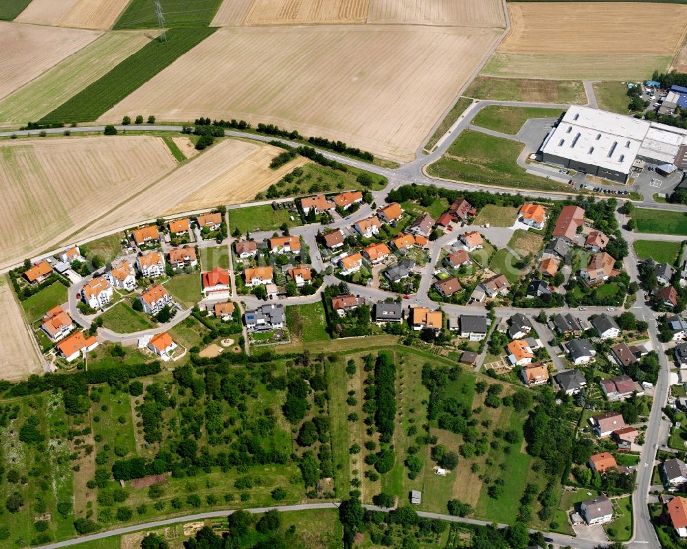 Frauenzimmern from the bird's eye view: Agricultural land and field boundaries surround the settlement area of the village in Frauenzimmern in the state Baden-Wuerttemberg, Germany