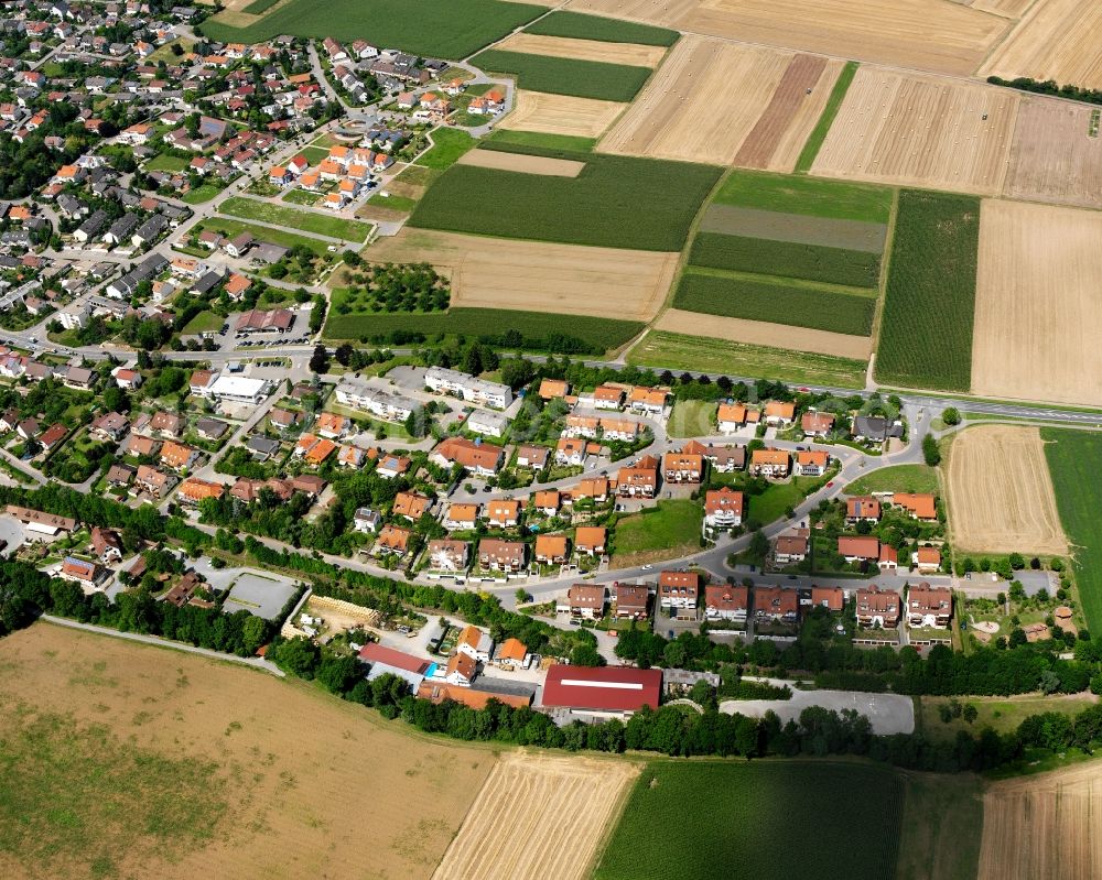 Aerial photograph Frauenzimmern - Agricultural land and field boundaries surround the settlement area of the village in Frauenzimmern in the state Baden-Wuerttemberg, Germany