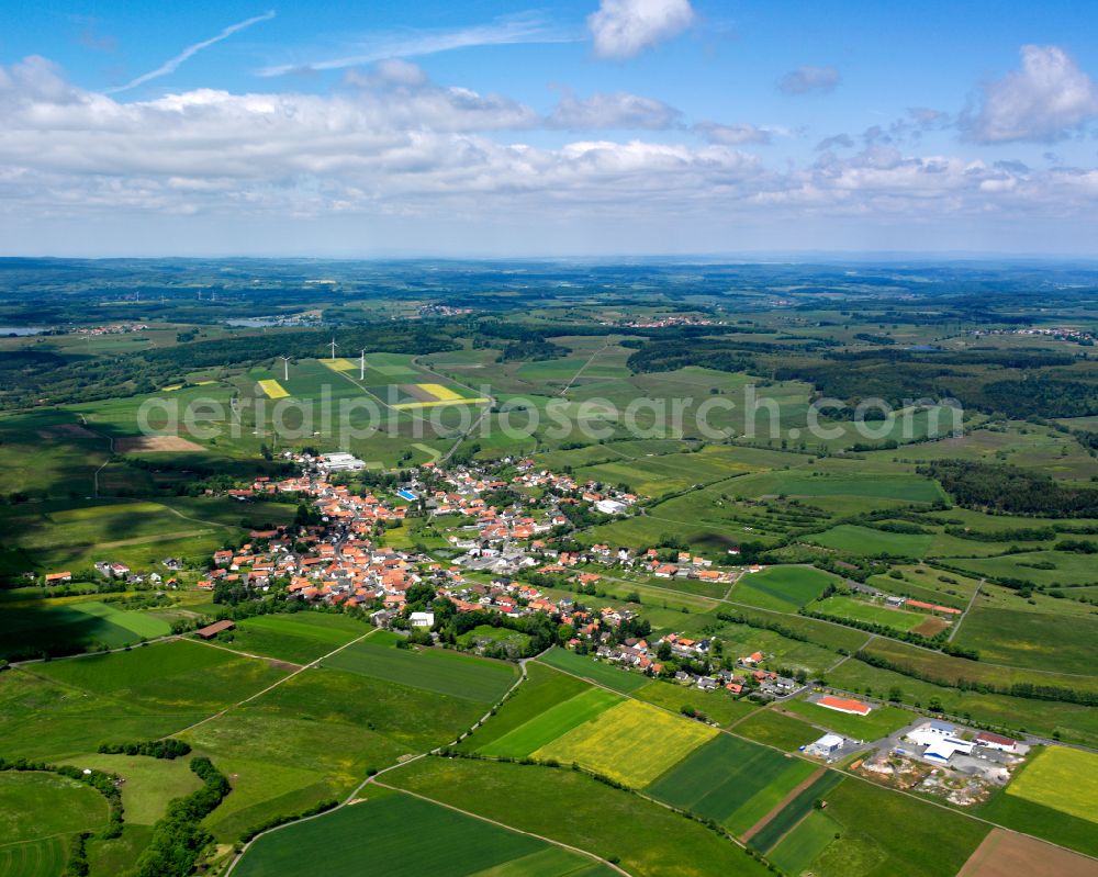 Aerial image Freiensteinau - Agricultural land and field boundaries surround the settlement area of the village in Freiensteinau in the state Hesse, Germany