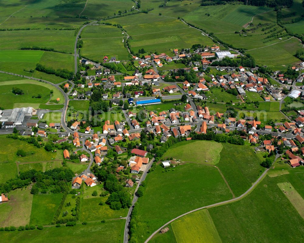 Aerial photograph Freiensteinau - Agricultural land and field boundaries surround the settlement area of the village in Freiensteinau in the state Hesse, Germany