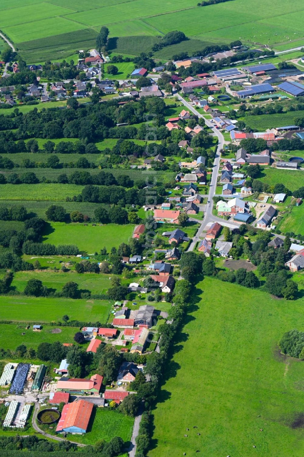 Friedrichsholm from the bird's eye view: Agricultural land and field boundaries surround the settlement area of the village in Friedrichsholm in the state Schleswig-Holstein, Germany