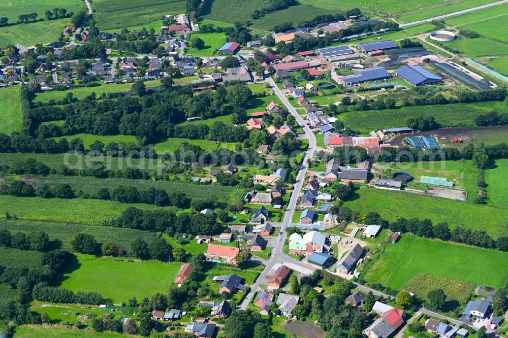 Friedrichsholm from above - Agricultural land and field boundaries surround the settlement area of the village in Friedrichsholm in the state Schleswig-Holstein, Germany