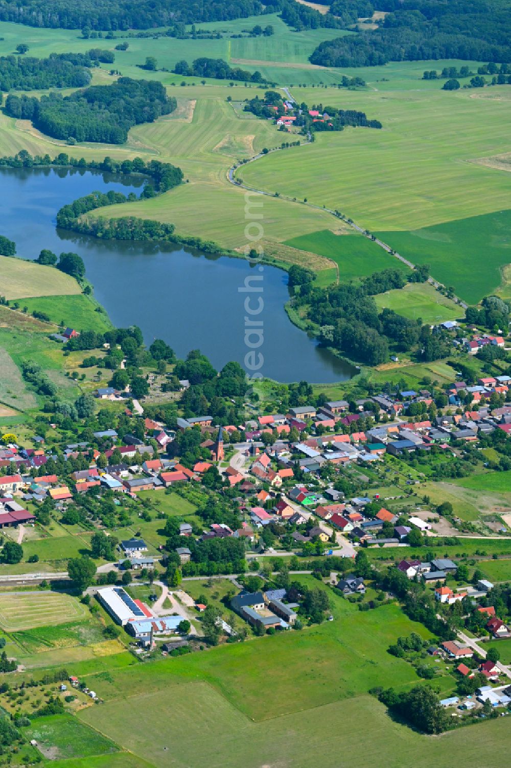 Aerial image Friedrichswalde - Agricultural land and field boundaries surround the settlement area of the village in Friedrichswalde in the state Brandenburg, Germany