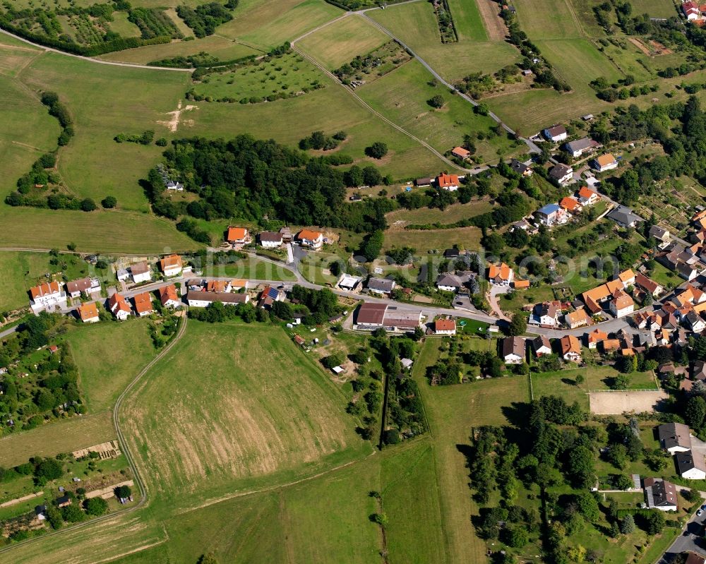 Aerial photograph Fränkisch-Crumbach - Agricultural land and field boundaries surround the settlement area of the village in Fränkisch-Crumbach in the state Hesse, Germany