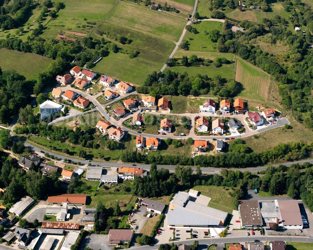 Fränkisch-Crumbach from above - Agricultural land and field boundaries surround the settlement area of the village in Fränkisch-Crumbach in the state Hesse, Germany