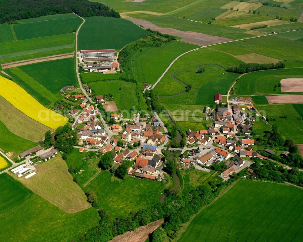 Frommetsfelden from above - Agricultural land and field boundaries surround the settlement area of the village in Frommetsfelden in the state Bavaria, Germany