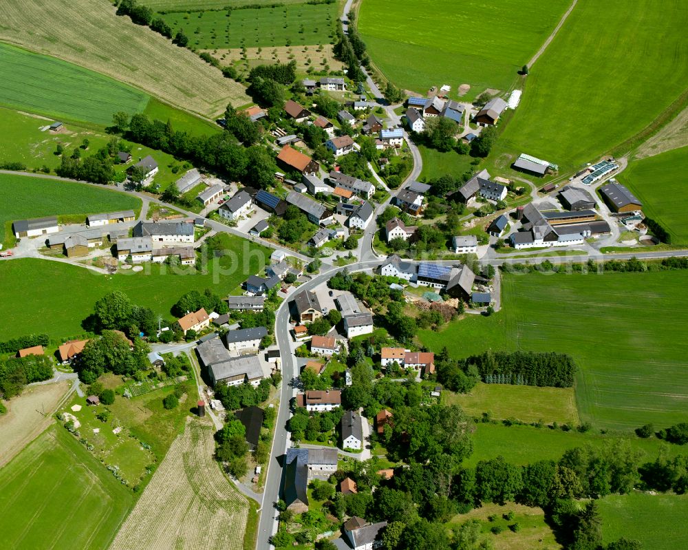 Förstenreuth from above - Agricultural land and field boundaries surround the settlement area of the village in Förstenreuth in the state Bavaria, Germany