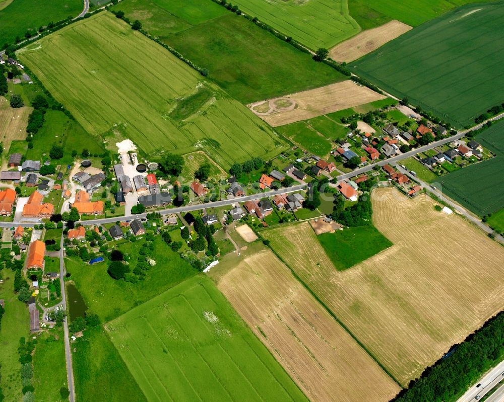 Fuhlenhagen from above - Agricultural land and field boundaries surround the settlement area of the village in Fuhlenhagen in the state Schleswig-Holstein, Germany