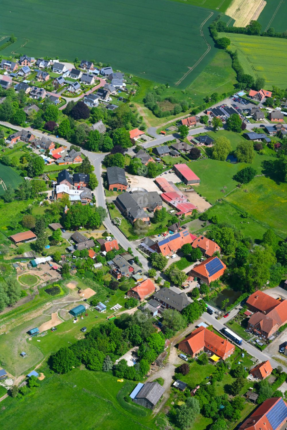 Fuhlenhagen from above - Agricultural land and field boundaries surround the settlement area of the village in Fuhlenhagen in the state Schleswig-Holstein, Germany