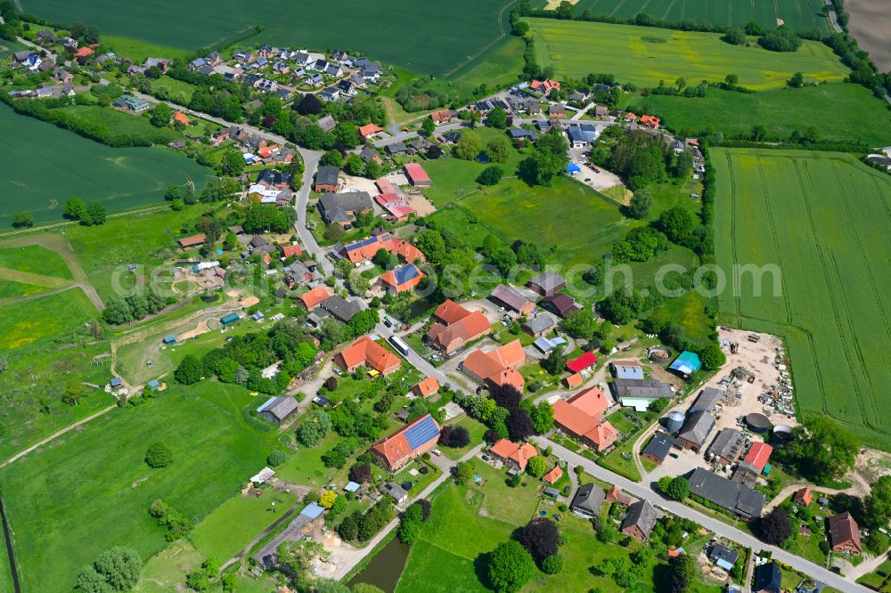 Fuhlenhagen from the bird's eye view: Agricultural land and field boundaries surround the settlement area of the village in Fuhlenhagen in the state Schleswig-Holstein, Germany