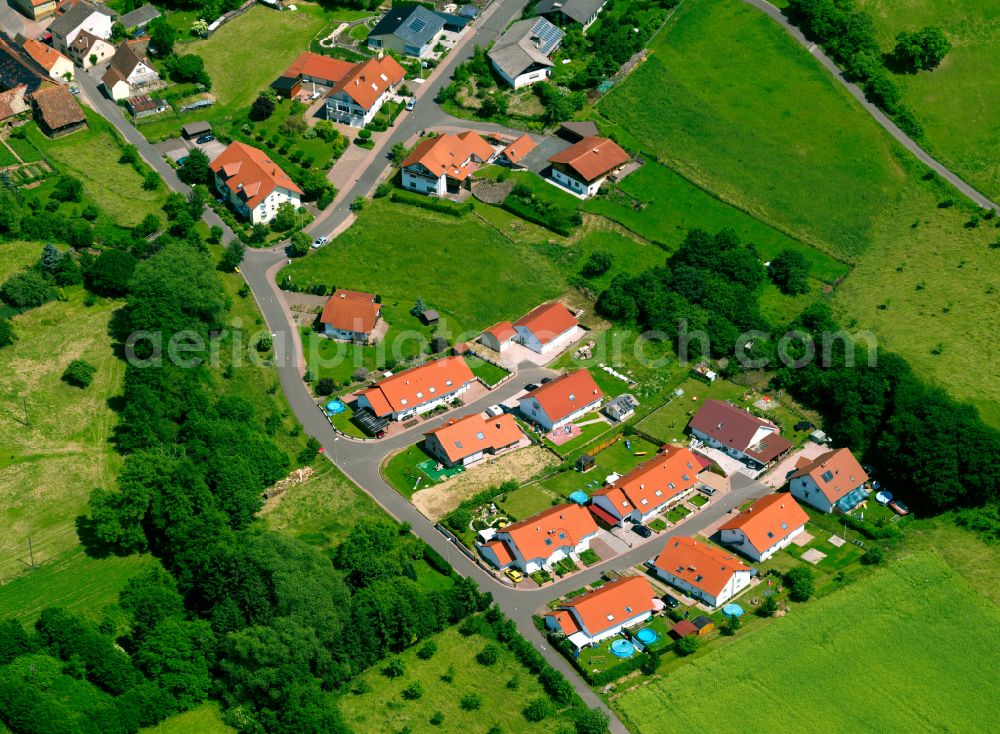 Gaugrehweiler from above - Agricultural land and field boundaries surround the settlement area of the village in Gaugrehweiler in the state Rhineland-Palatinate, Germany