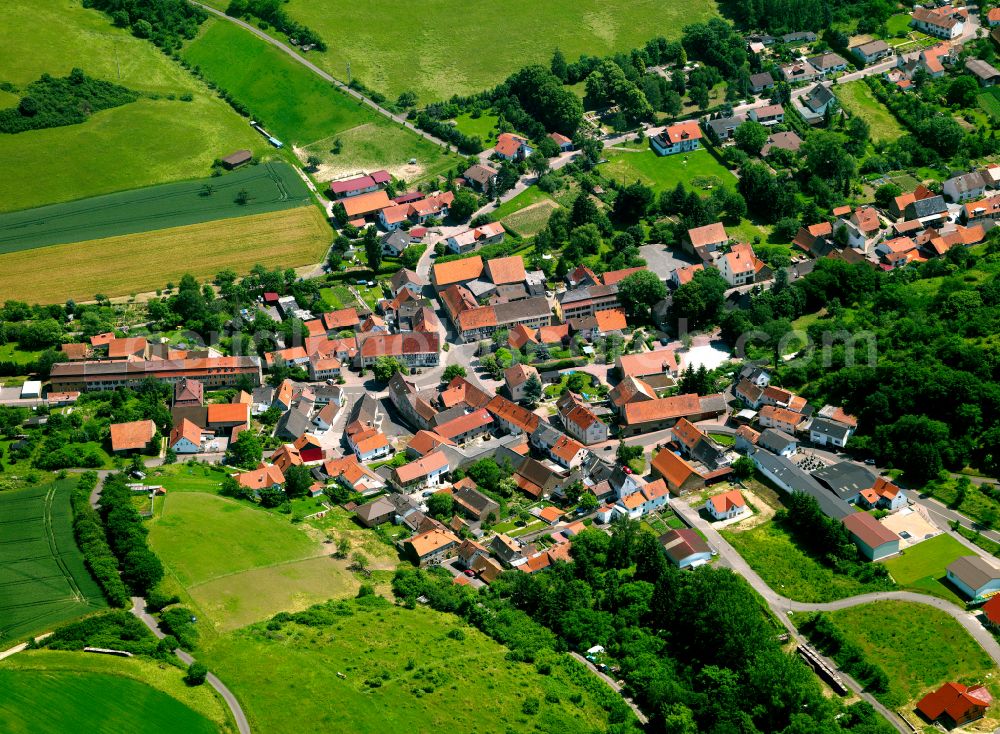 Gaugrehweiler from above - Agricultural land and field boundaries surround the settlement area of the village in Gaugrehweiler in the state Rhineland-Palatinate, Germany