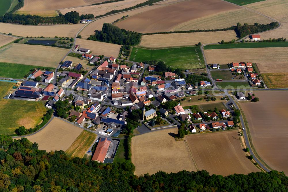 Gaurettersheim from the bird's eye view: Agricultural land and field boundaries surround the settlement area of the village in Gaurettersheim in the state Bavaria, Germany