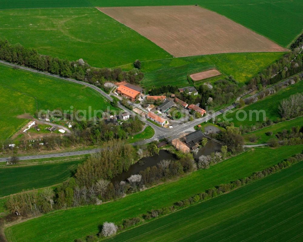 Gehau from above - Agricultural land and field boundaries surround the settlement area of the village in Gehau in the state Hesse, Germany