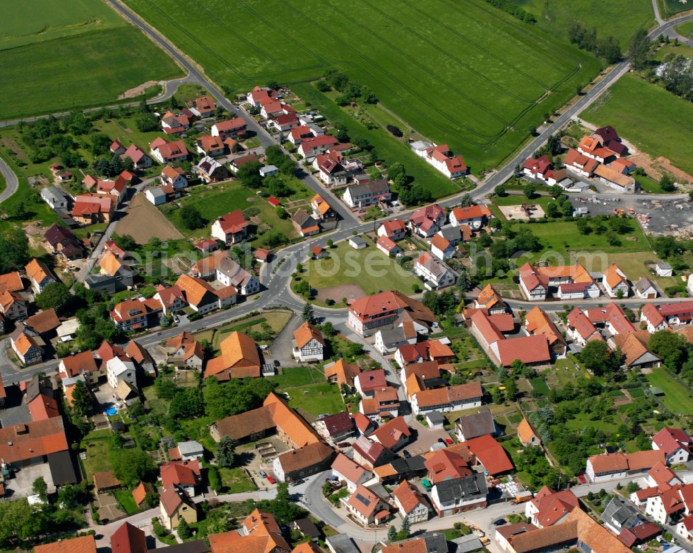 Gerbershausen from above - Agricultural land and field boundaries surround the settlement area of the village in Gerbershausen in the state Thuringia, Germany