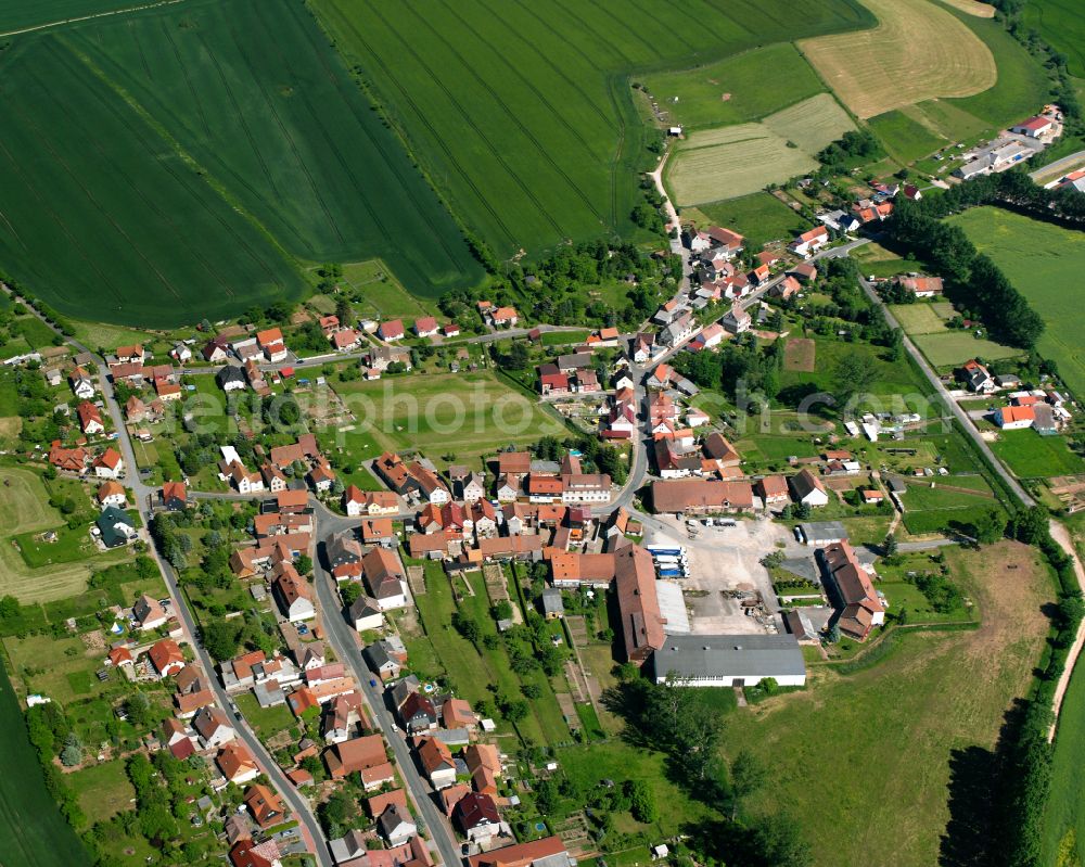 Gerterode from above - Agricultural land and field boundaries surround the settlement area of the village on street Baumgartenweg in Gerterode in the state Thuringia, Germany